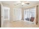 Bright bedroom featuring tile flooring, ceiling fan, closet, and sliding glass door to Florida room at 8506 Shady Glen Dr, Orlando, FL 32819