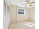 Sun-filled bedroom with tiled floors, neutral walls, and a large closet for ample storage at 8506 Shady Glen Dr, Orlando, FL 32819