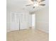 A bright bedroom showcases tile floors, neutral walls, and closet space at 8506 Shady Glen Dr, Orlando, FL 32819