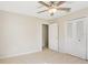 A calming bedroom showcases tile floors, neutral walls, and closet space at 8506 Shady Glen Dr, Orlando, FL 32819