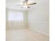 Bright bedroom featuring tile flooring, a ceiling fan, and neutral walls, creating a serene retreat at 8506 Shady Glen Dr, Orlando, FL 32819