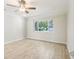 Bright bedroom with wood-look floors, neutral walls, and a large window at 8506 Shady Glen Dr, Orlando, FL 32819