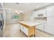 Bright kitchen open to the living room, island, and stainless steel appliances at 8506 Shady Glen Dr, Orlando, FL 32819