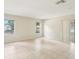Bright and airy living room with tile flooring, large windows, and neutral color palette at 8506 Shady Glen Dr, Orlando, FL 32819
