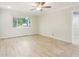 Bright living room with light wood flooring, modern ceiling fan, and a view to the backyard at 8506 Shady Glen Dr, Orlando, FL 32819