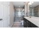 Modern bathroom featuring a glass-enclosed shower, sleek vanity, and tiled floors at 8643 Coventry Park Way, Windermere, FL 34786