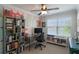 Bright bedroom with colorful painted accent wall, ceiling fan, and large window at 8643 Coventry Park Way, Windermere, FL 34786