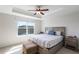 Serene bedroom with a tray ceiling, a large window, and a cozy, well-lit ambiance at 8643 Coventry Park Way, Windermere, FL 34786
