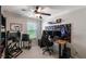 Modern bedroom featuring a ceiling fan, stylish wall art, and a sleek black gaming setup at 8643 Coventry Park Way, Windermere, FL 34786