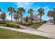 Well-manicured landscaping with palm trees and sidewalks enhancing the community's curb appeal at 8643 Coventry Park Way, Windermere, FL 34786