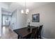 Inviting dining room featuring modern light fixture and dark wood table perfect for gatherings at 8643 Coventry Park Way, Windermere, FL 34786