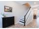 Spacious entryway featuring staircase, modern shoe cabinet, and artwork under subtle lighting at 8643 Coventry Park Way, Windermere, FL 34786