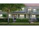 Charming two-story home with a covered front porch, manicured lawn, and a welcoming entrance featuring a decorative wreath at 8643 Coventry Park Way, Windermere, FL 34786