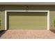Attached one-car garage door with brick paver driveway and house number displayed above at 8643 Coventry Park Way, Windermere, FL 34786