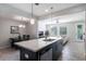 Open kitchen and dining area with large island, modern appliances, and a seamless layout for entertaining at 8643 Coventry Park Way, Windermere, FL 34786