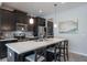 Modern kitchen featuring a quartz island, stainless steel appliances, and stylish dark cabinetry at 8643 Coventry Park Way, Windermere, FL 34786