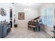 Stylish living room featuring a grand piano, wet bar, modern light fixture, and ample natural light at 8643 Coventry Park Way, Windermere, FL 34786