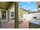 A patio with an outdoor kitchen area featuring a built-in grill, sink, and a table at 8643 Coventry Park Way, Windermere, FL 34786