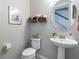 Charming powder room with decorative accents, a pedestal sink, and a round mirror at 8643 Coventry Park Way, Windermere, FL 34786