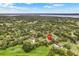 High angle aerial view of house with pool located in lushly landscaped community at 89 Pine Forest Ln, Haines City, FL 33844