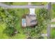 Aerial view of home with a screened pool, surrounded by lush greenery and mature trees, offering privacy at 89 Pine Forest Ln, Haines City, FL 33844