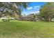 Expansive backyard featuring lush green grass and a screened-in patio for outdoor enjoyment at 89 Pine Forest Ln, Haines City, FL 33844