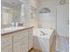 Bright bathroom with a large bathtub, white cabinets, and a neutral-toned countertop at 89 Pine Forest Ln, Haines City, FL 33844