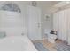 Bright bathroom featuring a tub and shower combination, with white tiling and neutral decor at 89 Pine Forest Ln, Haines City, FL 33844