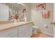 Bathroom featuring a large mirror, sink with vanity, toilet, and shower with a floral curtain at 89 Pine Forest Ln, Haines City, FL 33844