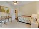 Bright bedroom featuring a bed with sunflower patterned bedding, desk area, and ceiling fan at 89 Pine Forest Ln, Haines City, FL 33844