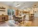 Dining area adjacent to kitchen features a table set for four, ample natural light, and wine storage at 89 Pine Forest Ln, Haines City, FL 33844