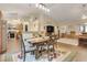Open-concept dining area featuring a wooden table with decorative rug and seamless flow to the living room and kitchen at 89 Pine Forest Ln, Haines City, FL 33844