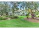 Well-maintained front yard and mature landscaping enhance the curb appeal of this home at 89 Pine Forest Ln, Haines City, FL 33844