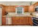 Kitchen with granite countertops, stainless steel appliances, wood cabinets, and modern fixtures at 89 Pine Forest Ln, Haines City, FL 33844