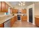Well-lit kitchen features stainless steel appliances, granite countertops, and wood cabinets at 89 Pine Forest Ln, Haines City, FL 33844