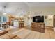 Open-concept living room flowing into dining area and kitchen, with a large TV and comfortable seating at 89 Pine Forest Ln, Haines City, FL 33844