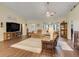 Cozy living room with wood flooring, a comfortable seating area, and a large flat-screen television at 89 Pine Forest Ln, Haines City, FL 33844