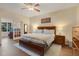 Spacious main bedroom with wood floors, a ceiling fan, and glass doors leading to another room at 89 Pine Forest Ln, Haines City, FL 33844