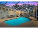 Beautiful pool area at dusk with ambient lighting and comfortable seating at 89 Pine Forest Ln, Haines City, FL 33844