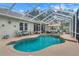 Inviting screened pool with spa and a relaxing outdoor lounging area at 89 Pine Forest Ln, Haines City, FL 33844