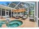 Outdoor oasis featuring a sparkling pool, spa, lounge chairs, and dining area at 89 Pine Forest Ln, Haines City, FL 33844
