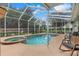 Screened-in pool and spa area with a spacious deck and rockin' chairs at 89 Pine Forest Ln, Haines City, FL 33844