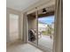 Balcony with sliding glass doors and cozy seating, offering tranquil views of the neighborhood at 9433 Randal Park Blvd, Orlando, FL 32832