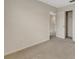 An airy bedroom features neutral carpet and paint, a closet, and an adjacent room at 9433 Randal Park Blvd, Orlando, FL 32832