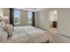 Bedroom showcasing natural light, neutral paint, a bed with white linens, and a glimpse of the bathroom at 9433 Randal Park Blvd, Orlando, FL 32832