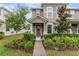 Charming two-story townhome with inviting front entrance and well-manicured landscaping at 9433 Randal Park Blvd, Orlando, FL 32832