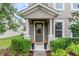 Inviting front porch with decorative flowerpots flanking the door and lush greenery at 9433 Randal Park Blvd, Orlando, FL 32832