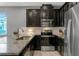 Close up of kitchen with stainless steel appliances, dark cabinets, granite countertops, and stainless faucet at 9433 Randal Park Blvd, Orlando, FL 32832
