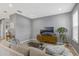 Cozy living room boasts tile floors, a large sectional, and neutral tones for a relaxing atmosphere at 9433 Randal Park Blvd, Orlando, FL 32832
