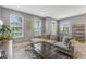 Bright and airy living room with a plush sectional sofa, multiple windows, and tile flooring at 9433 Randal Park Blvd, Orlando, FL 32832